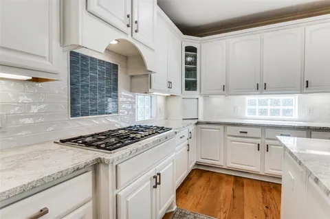 a kitchen with granite countertop cabinets stainless steel appliances and a counter space