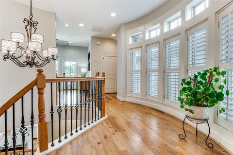a view of a porch with chairs and wooden floor