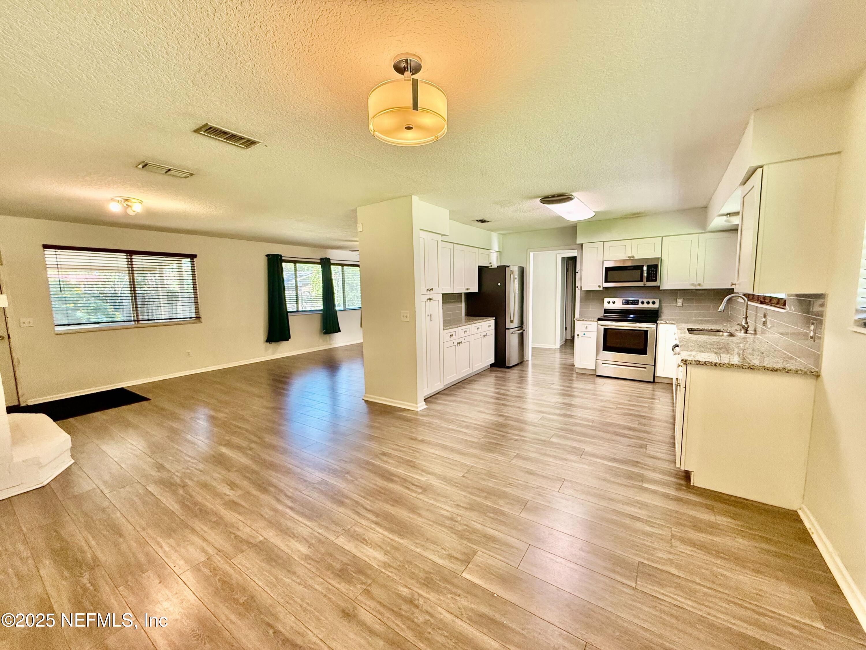 2349 Moody Avenue Orange Park, FL 32073 - Photo 3 of 10 a view of kitchen with cabinets and wooden floor