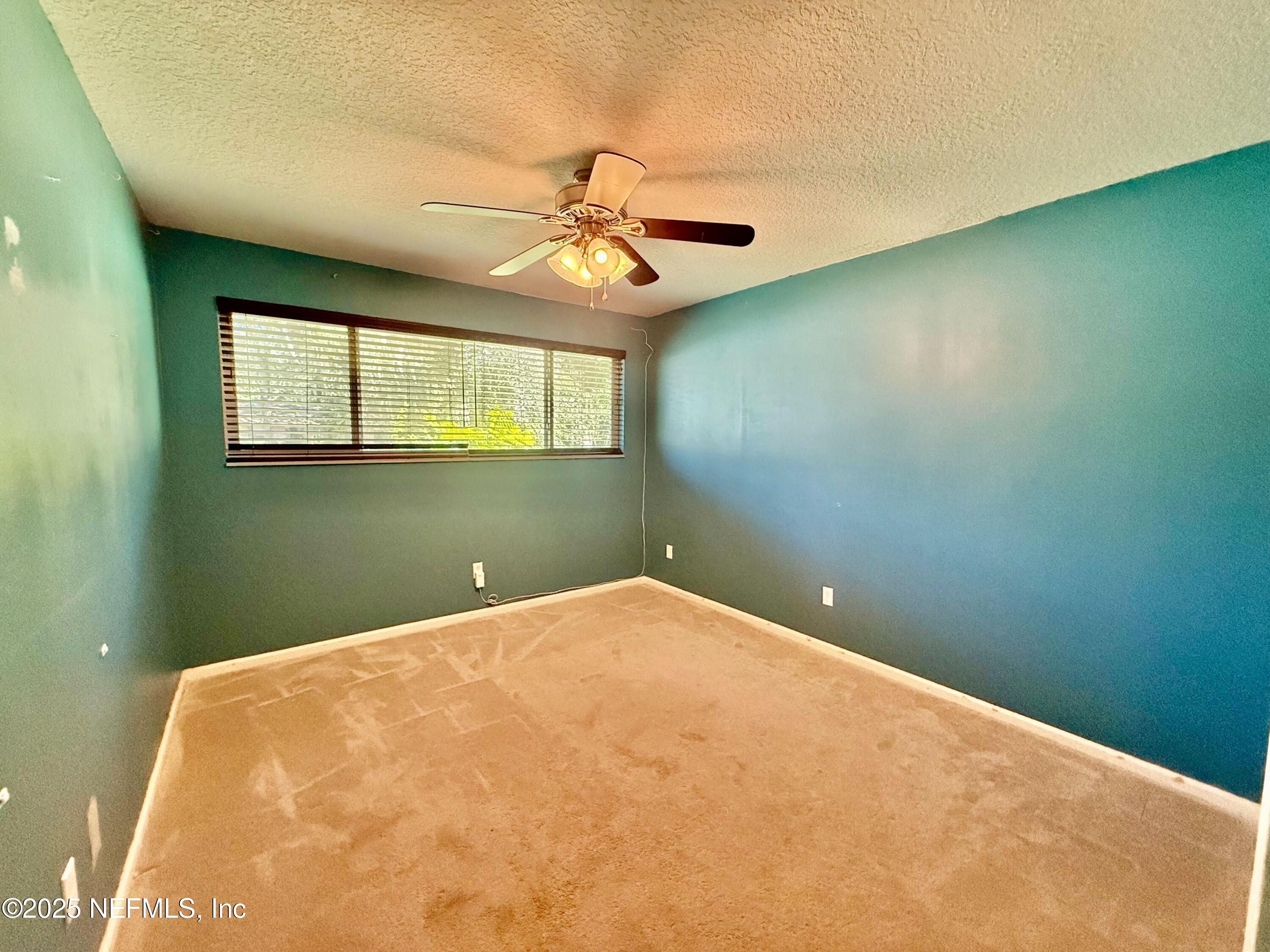 2349 Moody Avenue Orange Park, FL 32073 - Photo 6 of 10 a view of a big room with windows and ceiling fan
