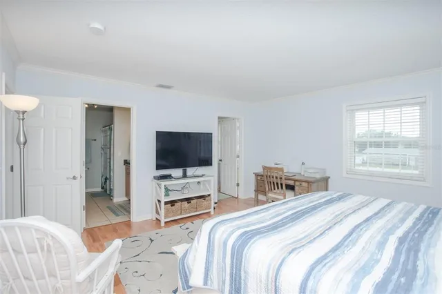 a bedroom with a bed and a flat screen tv