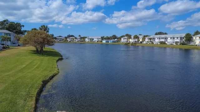 a view of a lake with houses in the back