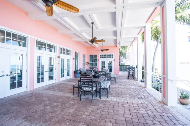 a dining room with furniture and large windows