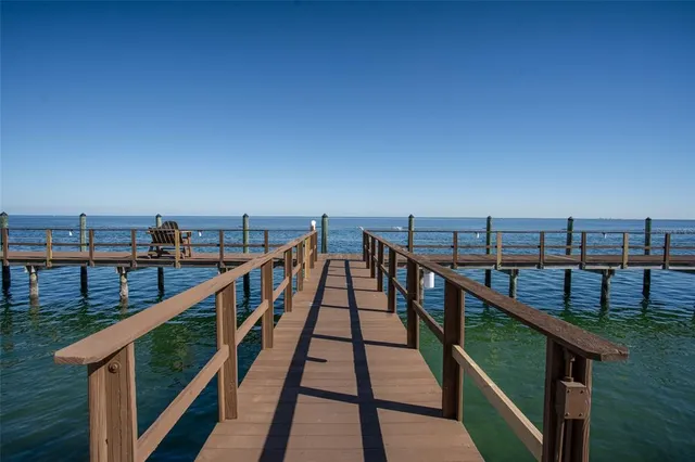 a view of staircase with railing and wooden floor
