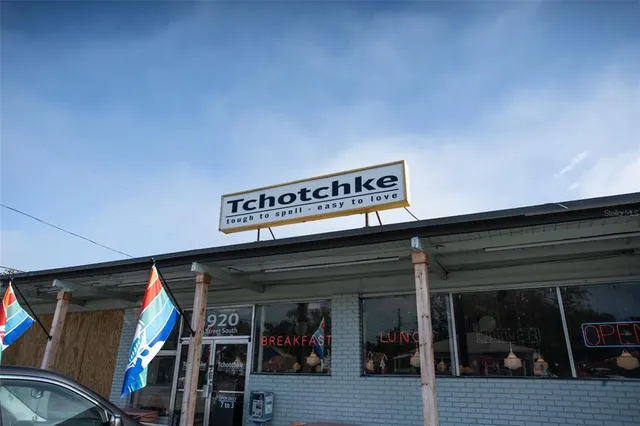 a view of a house with street and trees