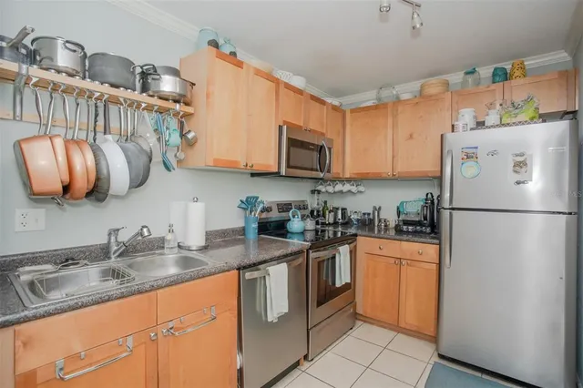 a kitchen with stainless steel appliances granite countertop a refrigerator sink stove and microwave