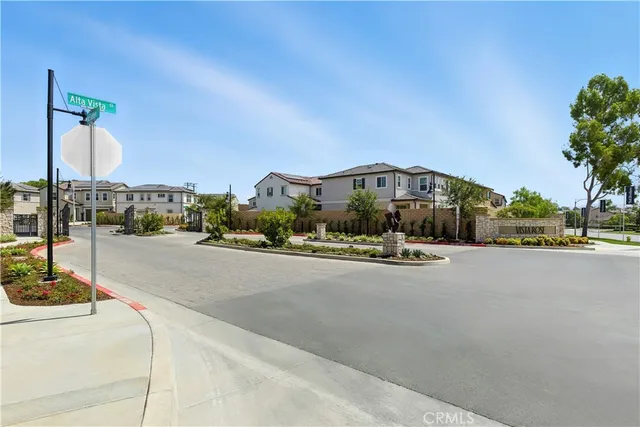 a city street with a building and couple of cars parked in front of it