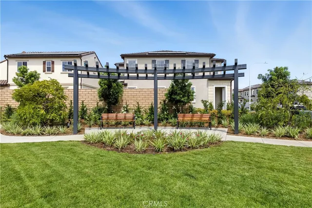 a front view of a house with a yard and lake view