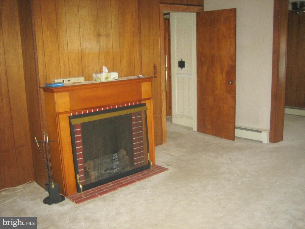 10012 Pitts Road Showell, MD 21862 - Photo 7 of 18 a view of an empty room with a fireplace