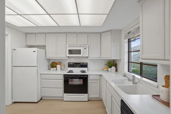 a kitchen with a sink a stove and refrigerator