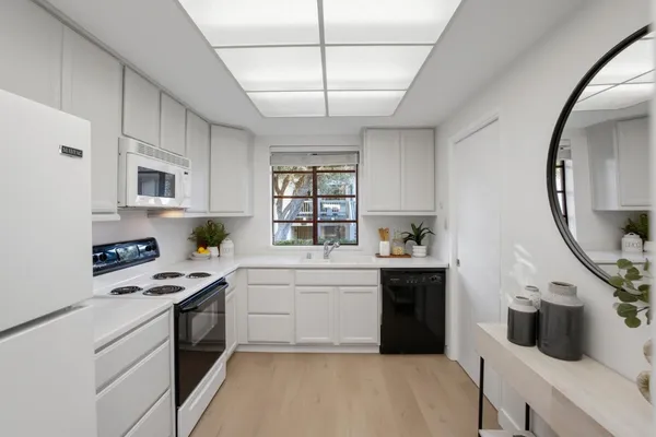 a kitchen with stainless steel appliances a sink stove and cabinets