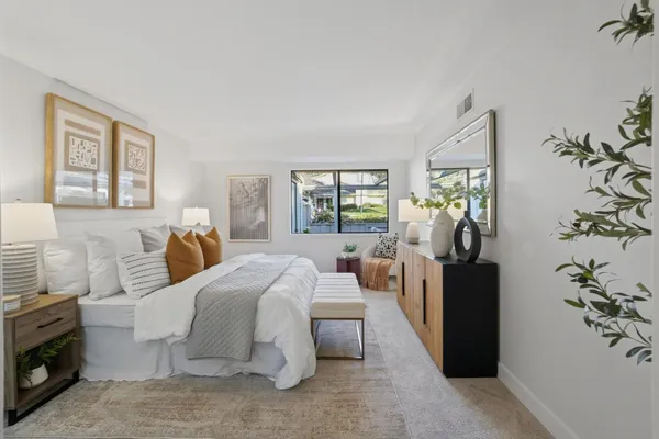 a bedroom with bed and glass door