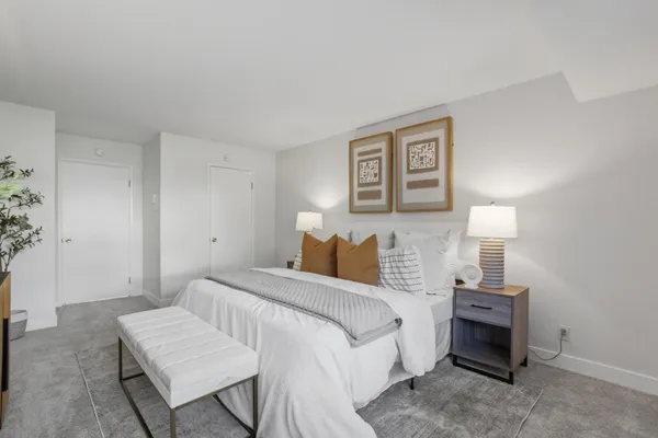 a bedroom with a bed and a lamp on table