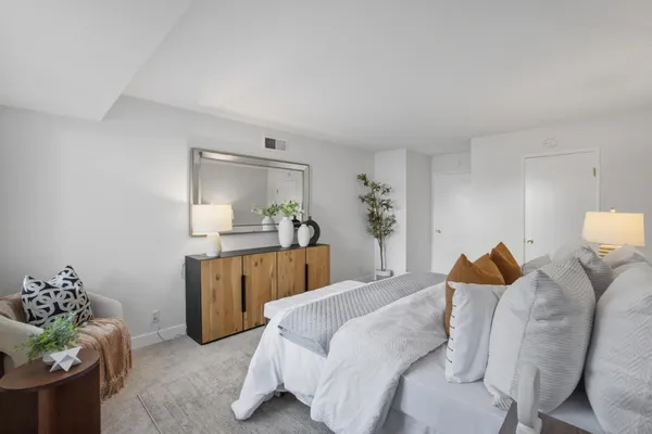 a bedroom with a bed and window