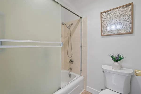 a bathroom with a shower and a toilet