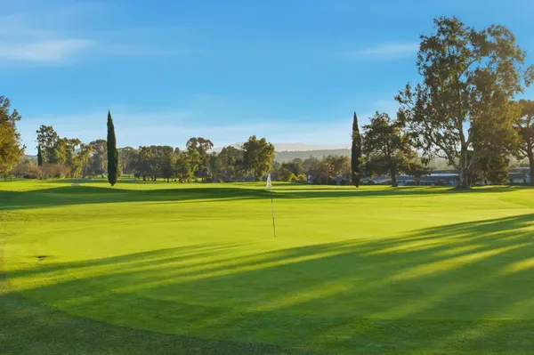 a view of a golf course with a lake