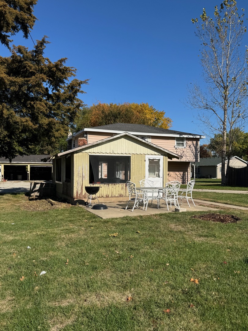 a view of a house with backyard porch and sitting area