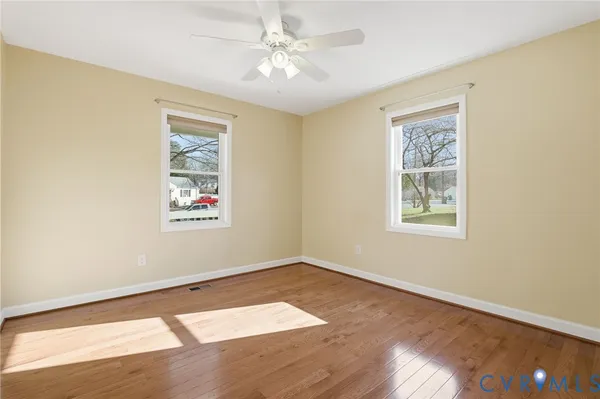 wooden floor in an empty room with a window