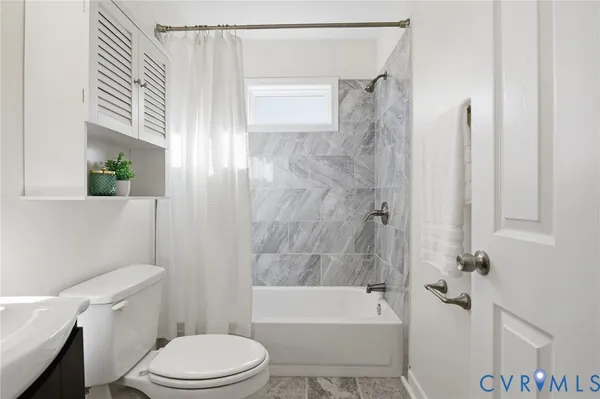 a bathroom with a toilet and shower