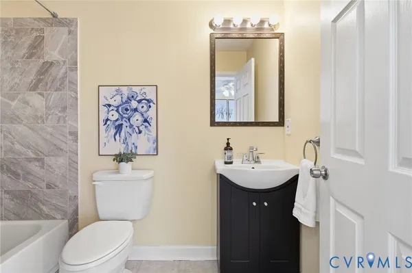 a bathroom with a toilet a sink and mirror