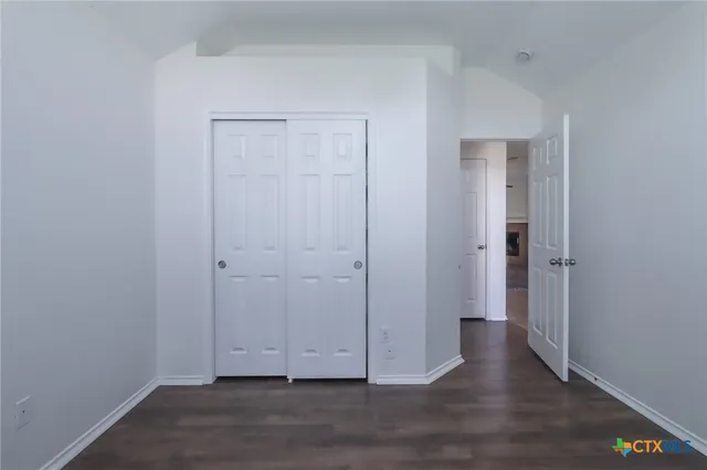 a view of room with wooden floor