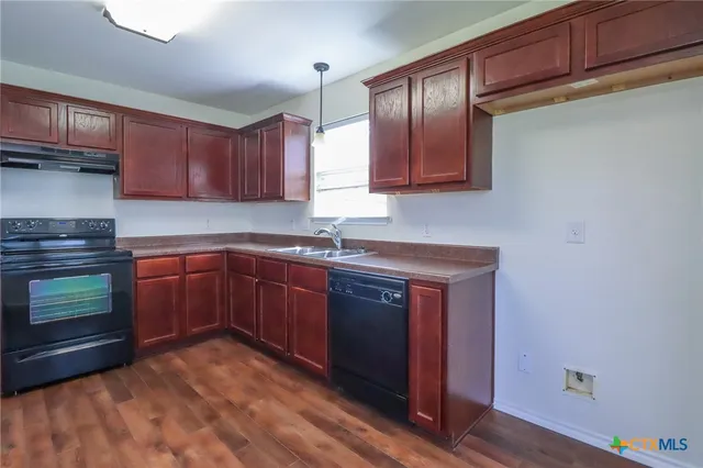 a kitchen with sink and cabinets