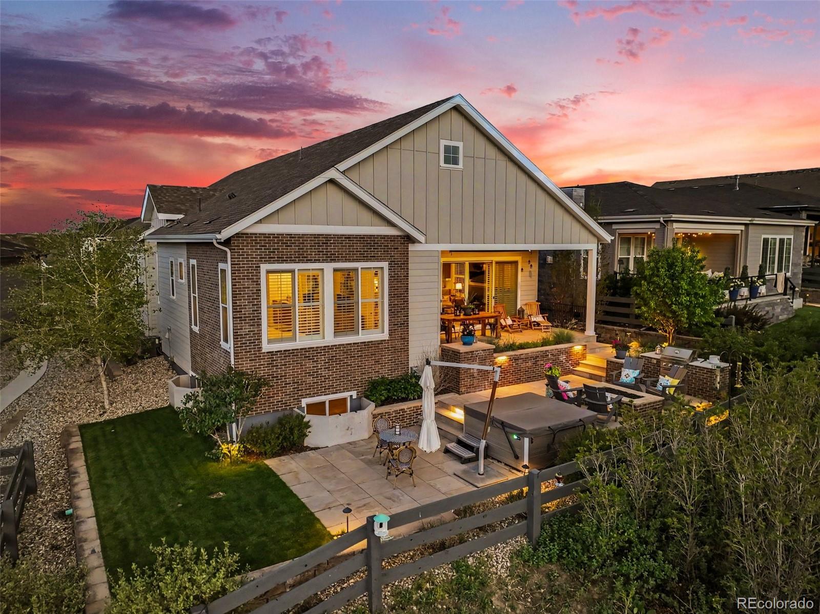 2101 Rim Ridge Drive Castle Pines, CO 80108 - Photo 43 of 50 a view of a house with backyard sitting area and garden