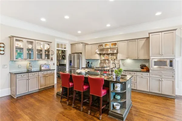 a dining room with furniture a chandelier and wooden floor