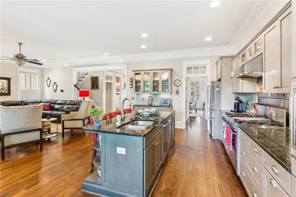 a kitchen with granite countertop a sink and cabinets