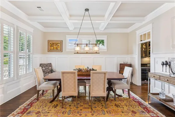 a dining room with furniture a rug and wooden floor