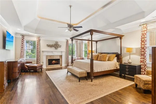 a spacious bedroom with a bed a couch and dresser