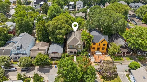 an aerial view of a house with swimming pool and outdoor space