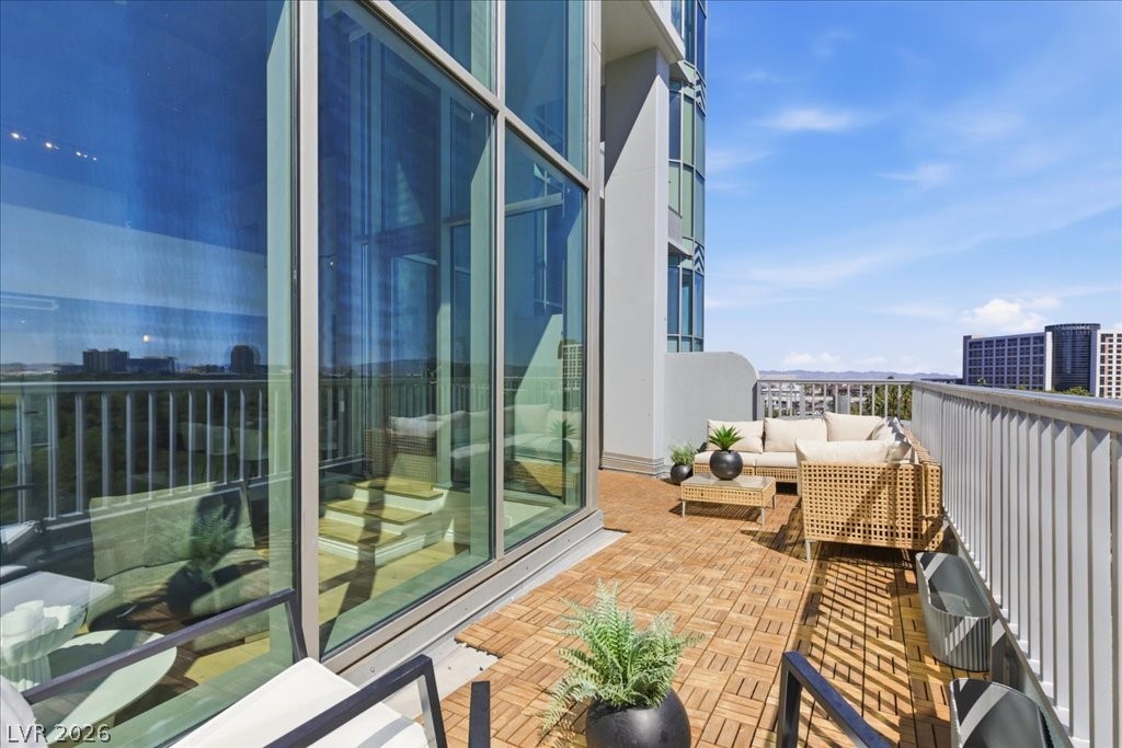 360 East Desert Inn Road, Unit 604 Las Vegas, NV 89109 - Photo 4 of 28 An inviting outdoor terrace with modern furnishings and expansive city views awaits.