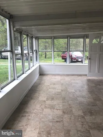 a view of an empty room with large windows