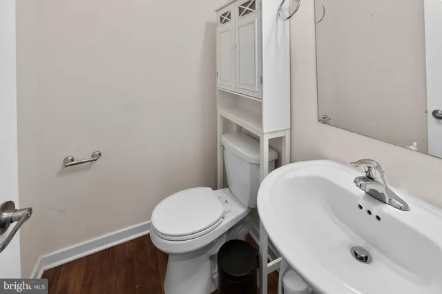 a bathroom with a sink a toilet and mirror