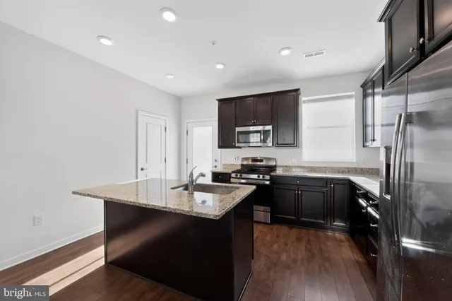 a kitchen with a sink appliances and cabinets