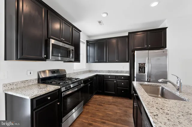 a kitchen with a sink stove and refrigerator
