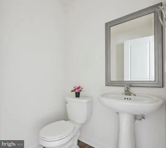 a bathroom with a sink a toilet and mirror