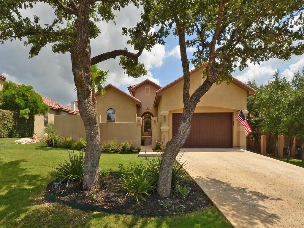 15206 Lariat Trail Austin, TX 78734 - Photo 1 of 1 a front view of a house with garden