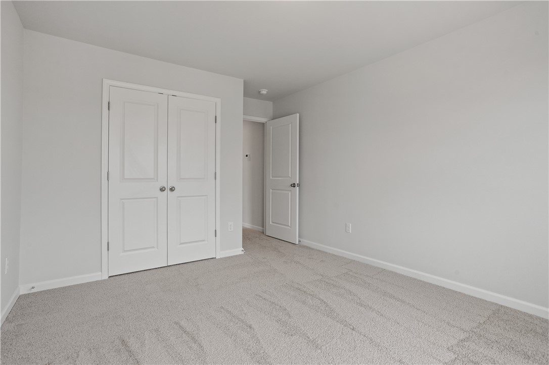 555 Hydrangea Street, Unit LOT 47 Seneca, SC 29678 - Photo 35 of 38 A spacious, neutral-toned room offers comfort and potential for personalization.