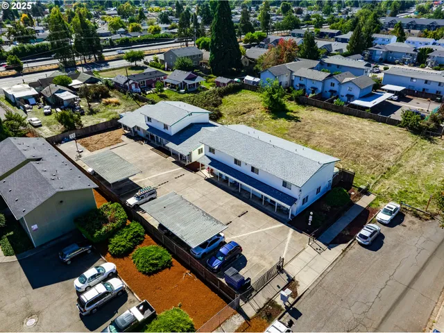 a open dining room with stainless steel appliances a sink table and chairs