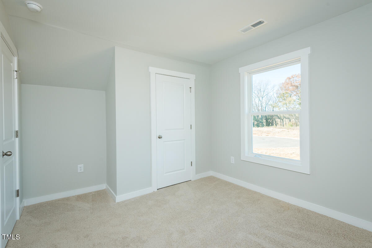 2812 Ricolden Trail Elon, NC 27244 - Photo 16 of 25 an empty room with windows