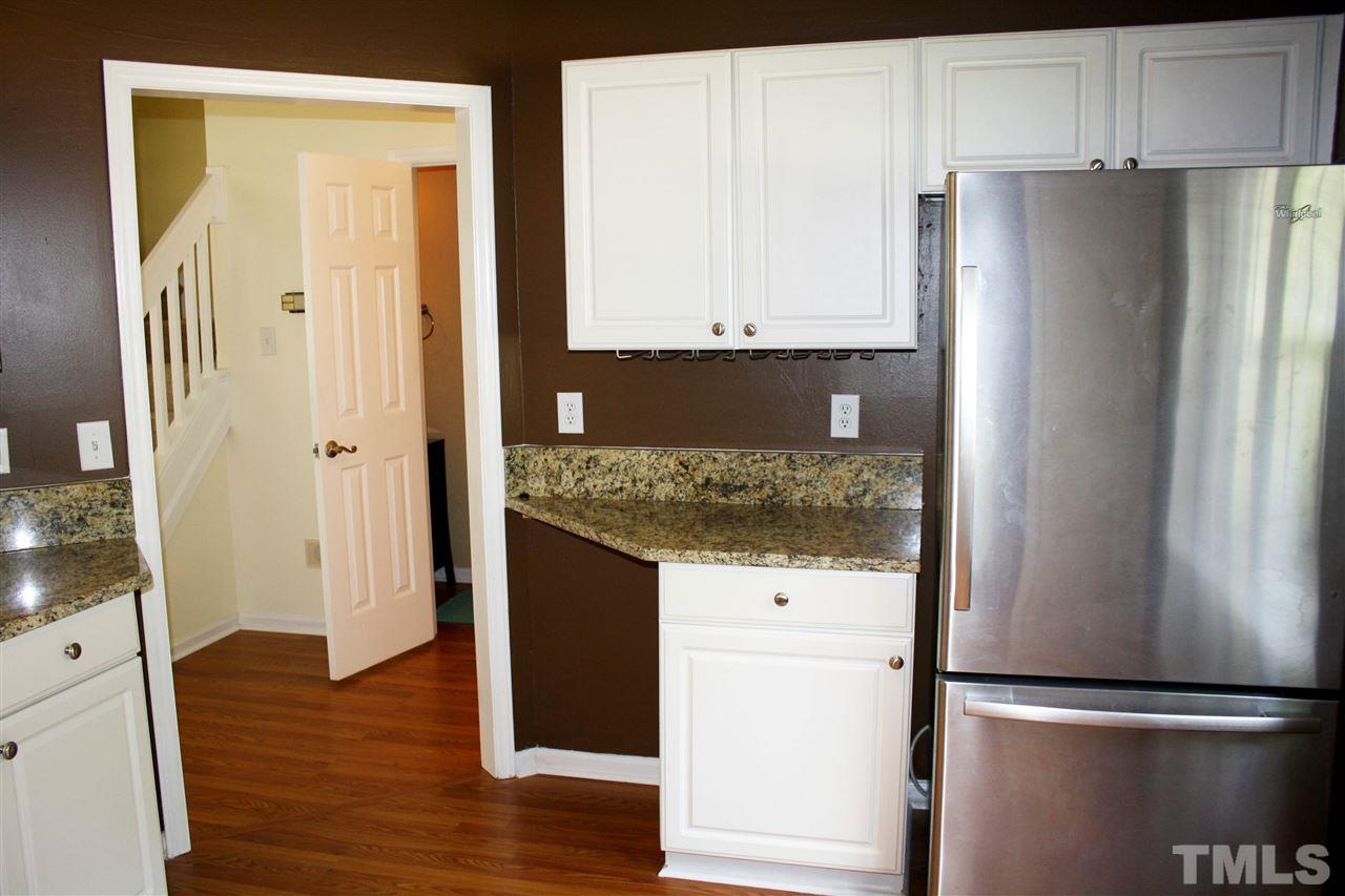 4435 Still Pines Drive Raleigh, NC 27613 - Photo 6 of 19 a kitchen with granite countertop a refrigerator and a sink