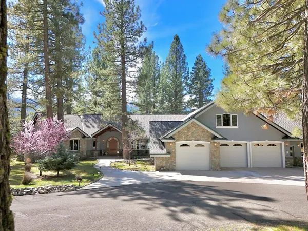 a view of house with wooden fence next to a road