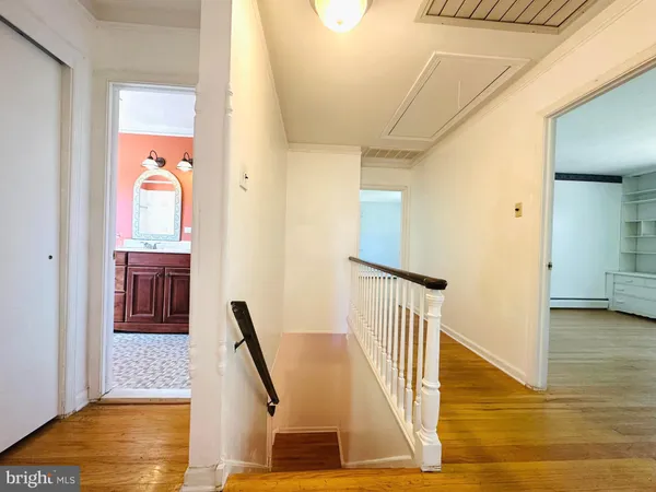 a big room with wooden floor and windows