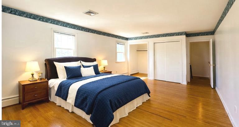 1626 Norristown Road Ambler, PA 19002 - Photo 37 of 57 a spacious bedroom with a bed and wooden floor