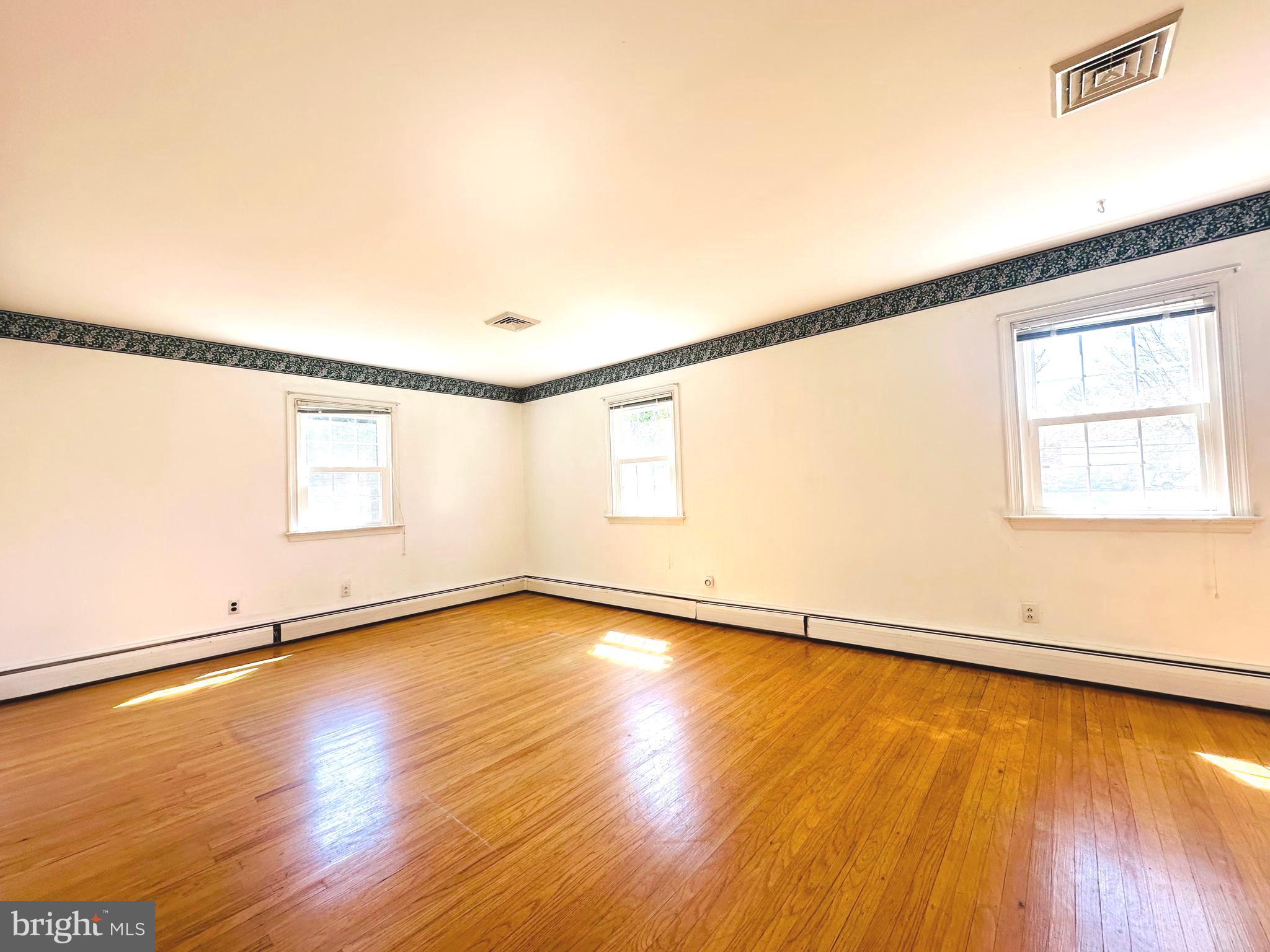 1626 Norristown Road Ambler, PA 19002 - Photo 40 of 57 a view of an empty room with wooden floor and a window