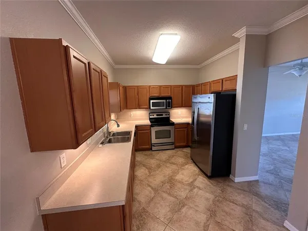 a kitchen with stainless steel appliances granite countertop a refrigerator and a stove