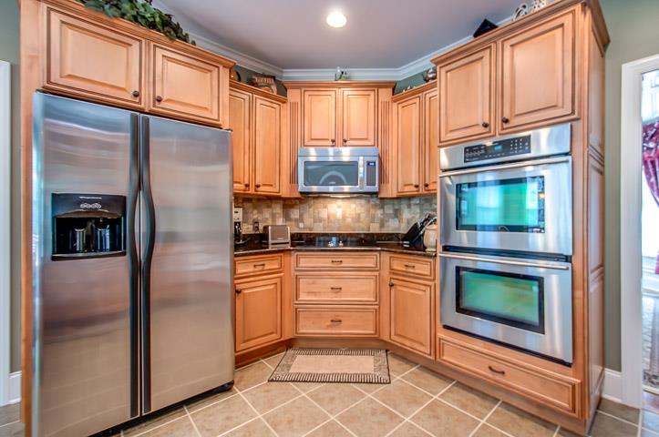 1227 White Rock Road Spring Hill, TN 37174 - Photo 13 of 29 a kitchen with stainless steel appliances granite countertop a refrigerator microwave and stove top oven