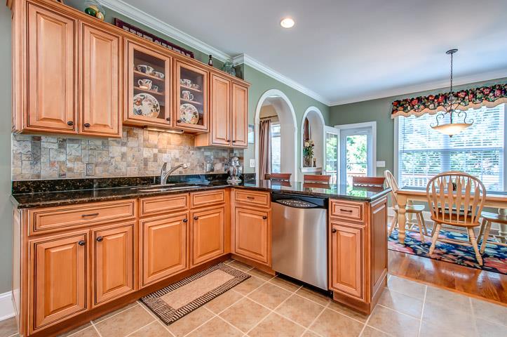 1227 White Rock Road Spring Hill, TN 37174 - Photo 14 of 29 a kitchen with stainless steel appliances granite countertop a stove a sink and white cabinets with wooden floor